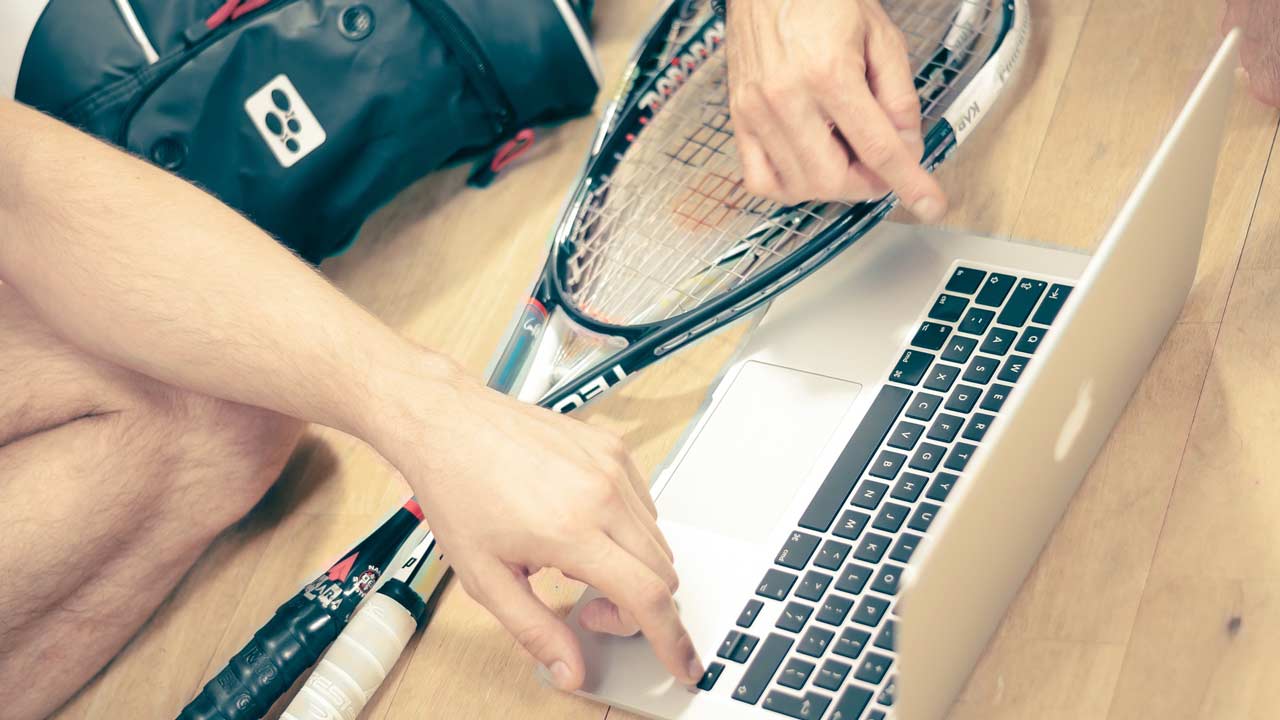 Laptop and squash racket